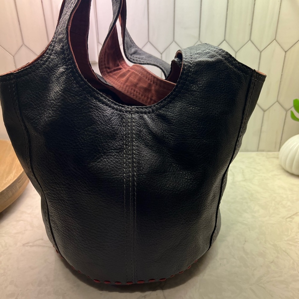 Lucky purse. Black leather with maroon accents